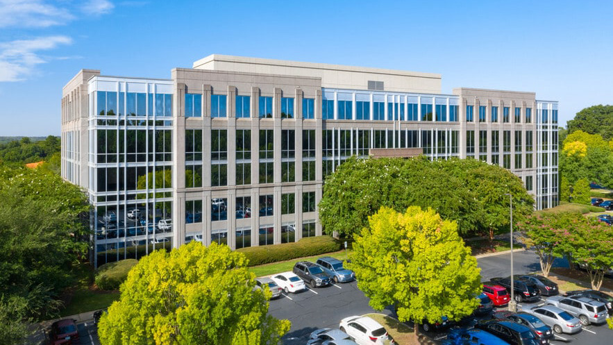 Modern Framatome office building in Charlotte North Carolina with city skyline visible in the background